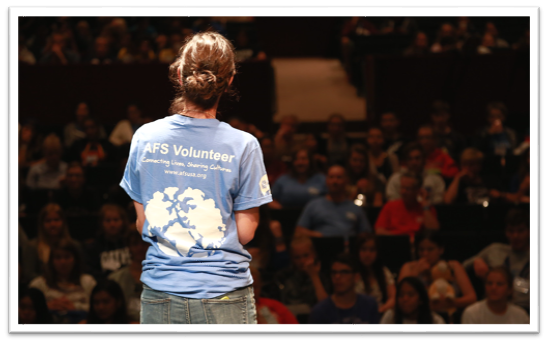A person standing in front of a crowd

Description automatically generated with medium confidence