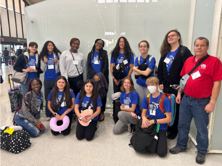 A group of people posing for a photo

Description automatically generated